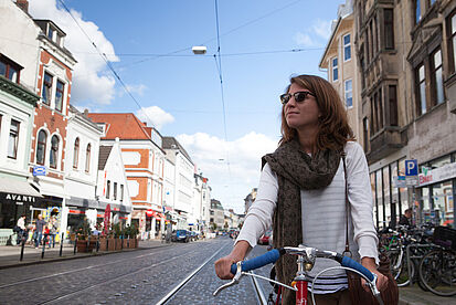 girl riding a bike through Bremen