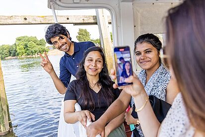 three students on the Weser ferry taking a group picture