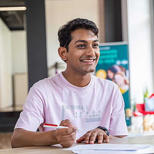 Indischer Student füllt Formular aus